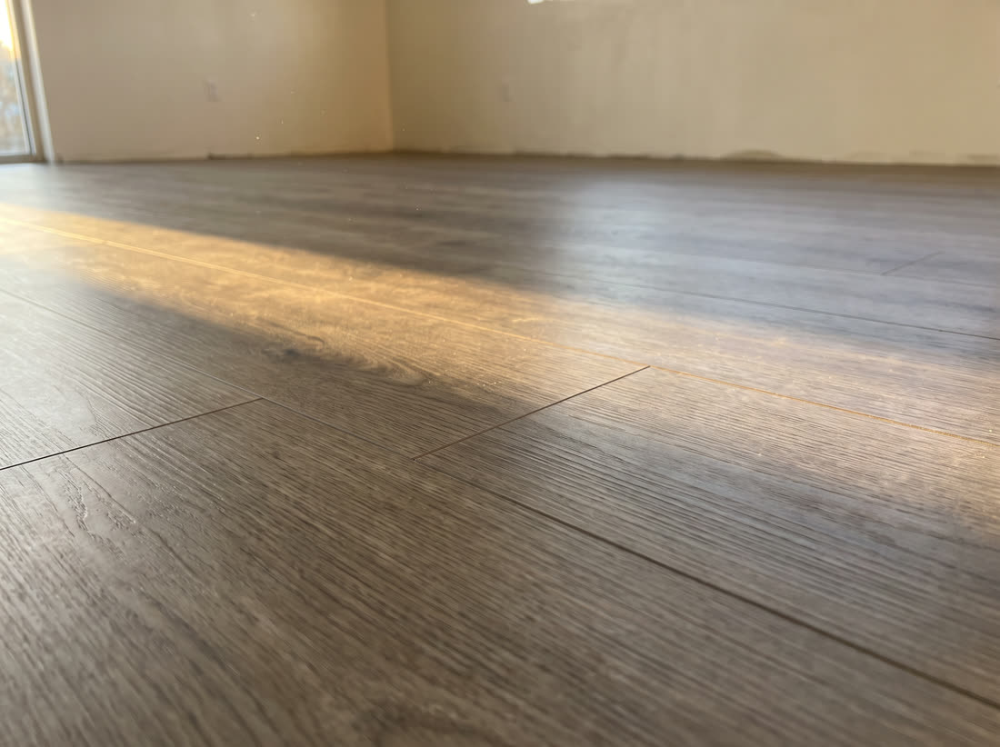 Glue down luxury vinyl bonded flat with a soft satin sheen and near invisible seams.