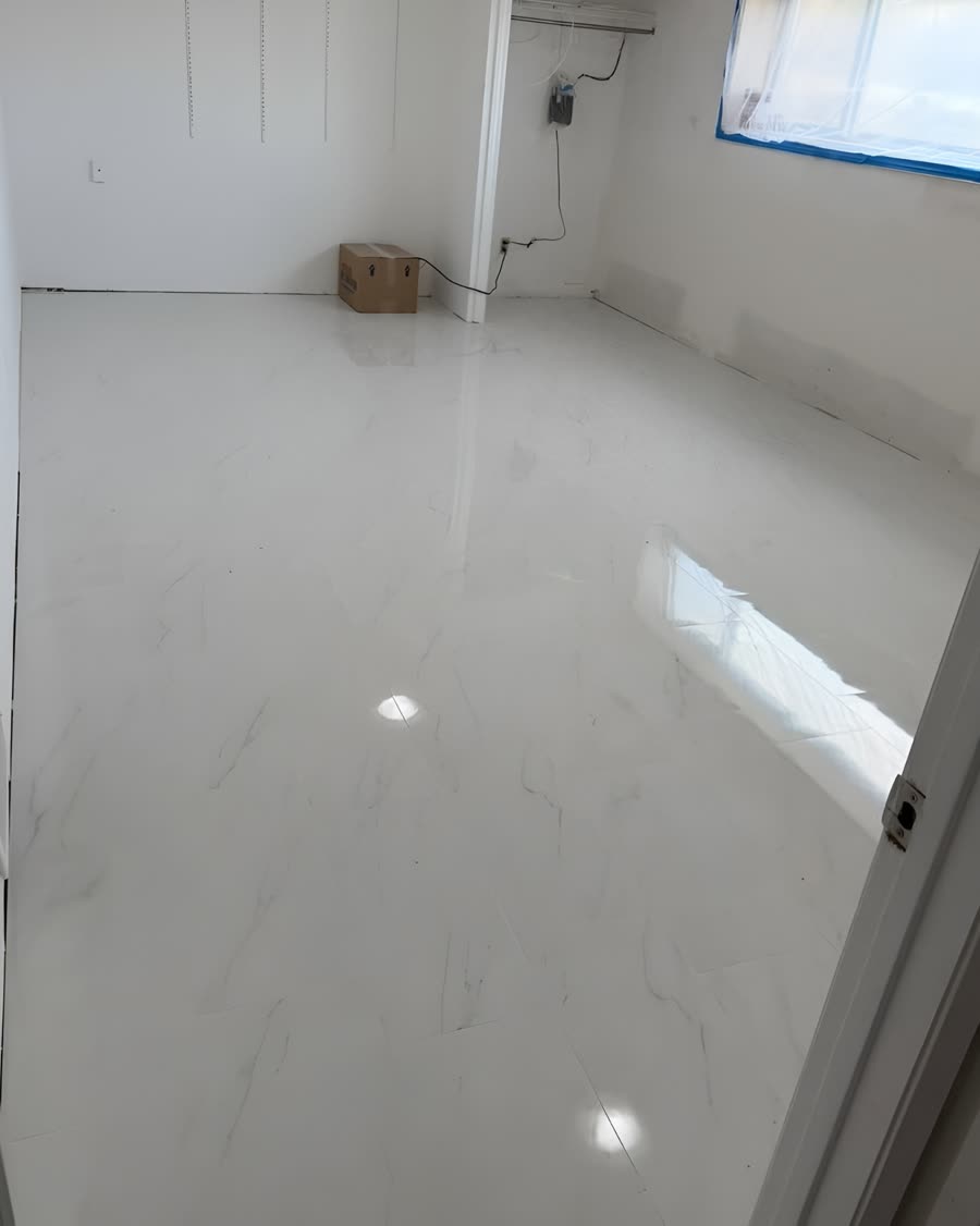 Polished marble effect ceramic tile covering a bedroom floor.